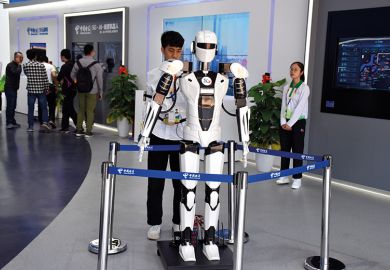 Young Asian man with robot