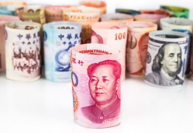 Rolled-up bank notes with Chinese currency at front