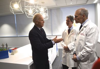 Joe Biden (L) meets with (C-R) Dr. Bruce Levine and Dr. Carl June, while touring the University of Pennsylvania, Perelman School of Medicine and Abramson Cancer Center in Philadelphia, Pennsylvania January 15, 2016.