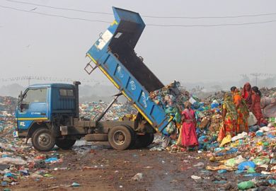 Poor people in a rubbish dump