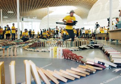 Running with camera to capture book domino chain Running with camera to capture book domino chain