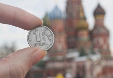 Russian ruble Ruble held by st.Basil's Cathedral