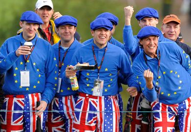 Golf fans wearing flags of the UK, EU and USA at the Ryder Cup golf competition between US and Europe. To illustrate that the UK and Europe should woo disaffected American scientists.