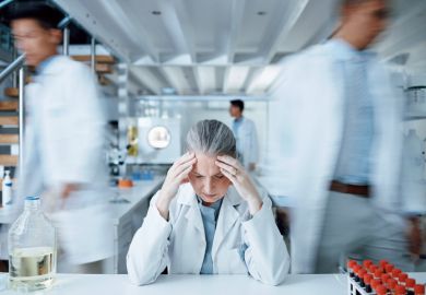 A worried scientist in a lab, symbolising research culture