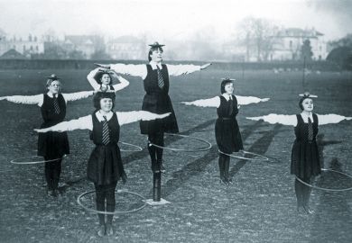 schoolgirls balancing a ball and plate on their heads while spinning a hoop schoolgirls balancing a ball and plate on their heads while spinning a hoop
