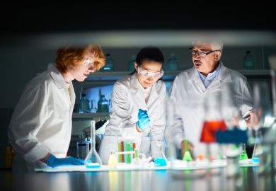 Scientists with liquids of various colours in test tubes, symbolising policy options