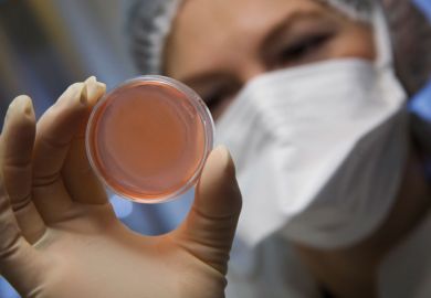 Scientist holding a petri dish