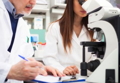 Scientists collaborating in laboratory