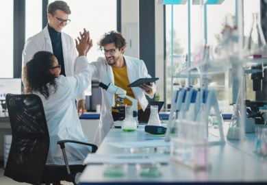 Scientists high-fiving, symbolising research culture