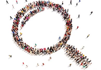 Large group of people in the shape of a magnifying glass, symbolising shared vision
