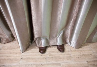 Shoes visible beneath curtain
