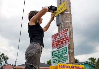 Woman puts up sign