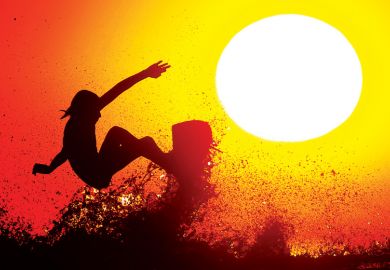 Silhouette of person surfing on wave at dawn