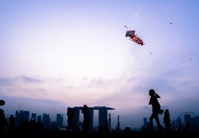 Singapore, Singapore - August 22th, 2015 The kids are playing with the kite on top of the Marina Barrage. Singapore, Singapore - August 22th, 2015 The kids are playing with the kite on top of the Marina Barrage.