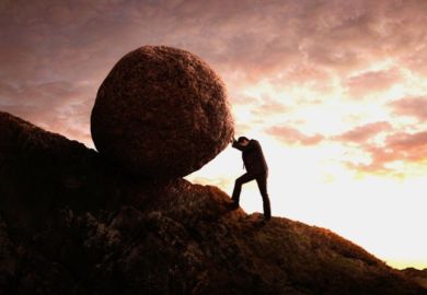A businessman rolls a rock up a hill like Sisyphus