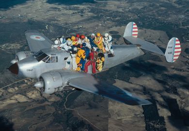 Skydivers holding on to aeroplane in flight Skydivers holding on to aeroplane in flight