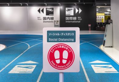 Social-distancing sign with footprints icon at Tokyo airport