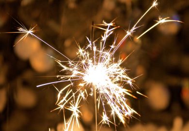 A sparkler held in someone’s hand