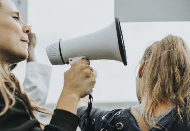 Speaking into megaphone