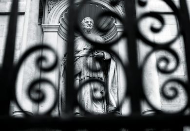 Statue behind a fence