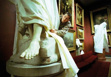Statue being covered with a dust sheet. To suggest there is less on show for A Level students who are choosing a less diverse range of subjects. 