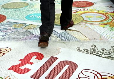 A pedestrian crosses the Millenium Bridge as MasterCard signage depicting banknotes carpets the bridge to launch its "PayPass" cashless card system, in London, U.K., 2007. To illustrate stepped loan repayments.
