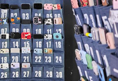 Storage of mobile phones in numbered pouches. To illustrate device-free classrooms.