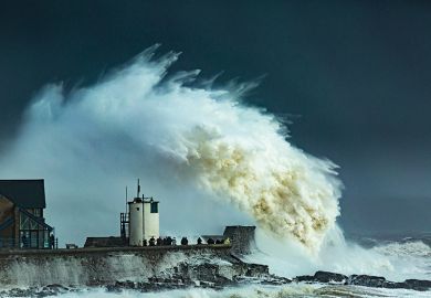Huge wave crashes on pier