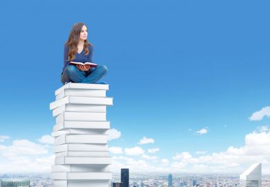 Student sitting high above city