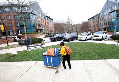 Towson University students remove their belongings from dorms