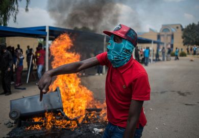 Students shout slogans next to a burning barricade during clashes with South African anti-riot police and campus security at a demonstration in support of the Fees Must Fall movement in 2016 Students shout slogans next to a burning barricade during clashes with South African anti-riot police and campus security at a demonstration in support of the Fees Must Fall movement in 2016