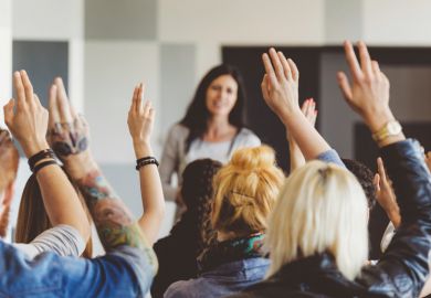 Students raising hands during lecture