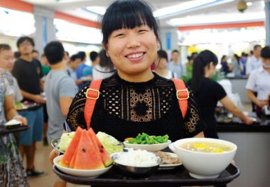 Sun Yat-sen University student holding tray of food