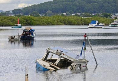 Half sunken wooden boat with just the cabin showing
