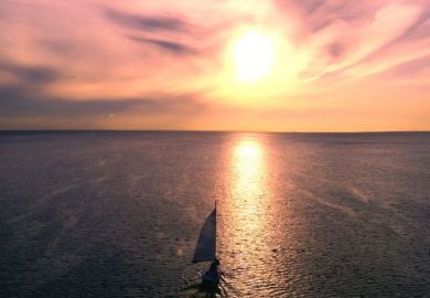 A yacht sailing into the sunset, illustrating retirement