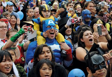 Father and son dressed as superheroes