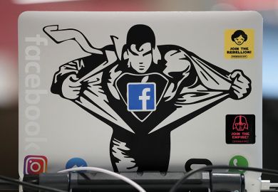 Superman sticker on Macbook computer