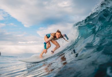 A woman surfing a large wave A woman surfing a large wave