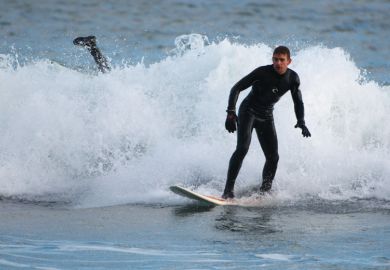 Surfer wiping out in small wave, Aberdeen Beach, Scotland Surfer wiping out in small wave, Aberdeen Beach, Scotland