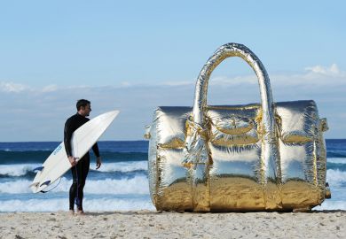 Surfer with a giant handbag