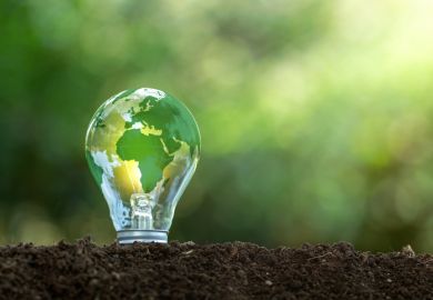 A lightbulb with a green earth on it, symbolising sustainable development