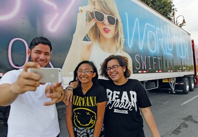 Taylor Swift fans in front of one of the many semi-trucks n Houston to illustrate For Taylor Swift, lecturers find a place in this world