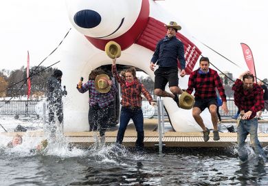 Participants jump into the water during the Minnesota Polar Plunge to illustrate Teach for America at turning point as numbers participating drop off 