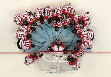 Team Canada in huddle on rink, Winter Olympic Games, 2010