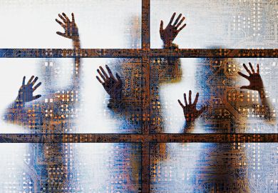 People outlined behind a screen showing computer circuitry