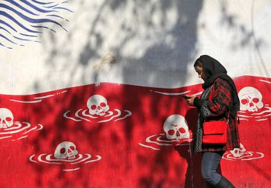 A woman walks past an anti-American murals following a possible US intervention against Iran on 28 January, 2026 in Tehran, Iran. A woman walks past an anti-American murals following a possible US intervention against Iran on 28 January, 2026 in Tehran, Iran.
