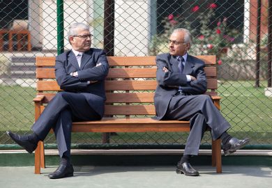 Two men facing each other on a bench