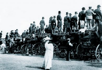 Woman standing behind men on coaches