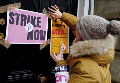 A demonstrator sticks a poster to a door as members of the University and College Union (UCU) stand at a picket line in protest against university lecturers' pay and pensions, outside of an entrance at University College London (UCL) in central London A demonstrator sticks a poster to a door as members of the University and College Union (UCU) stand at a picket line in protest against university lecturers' pay and pensions, outside of an entrance at University College London (UCL) in central London