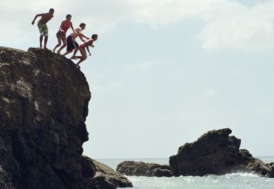 Group of people jumping in to the sea from a cliff
